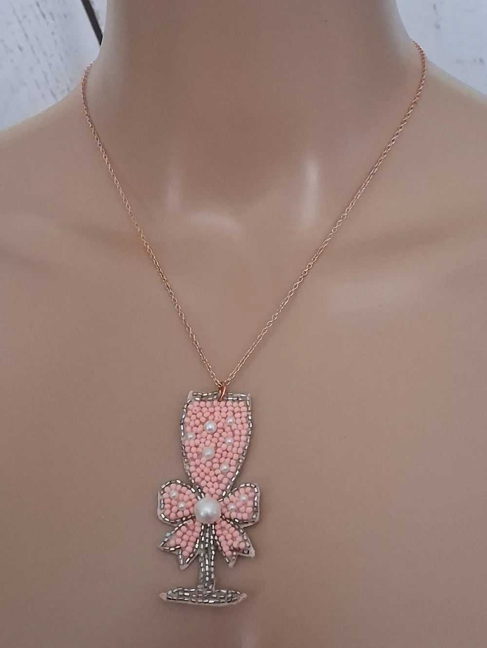 Pink Beaded Champagne Glass Pendant Necklace On A Rose Gold Chain.